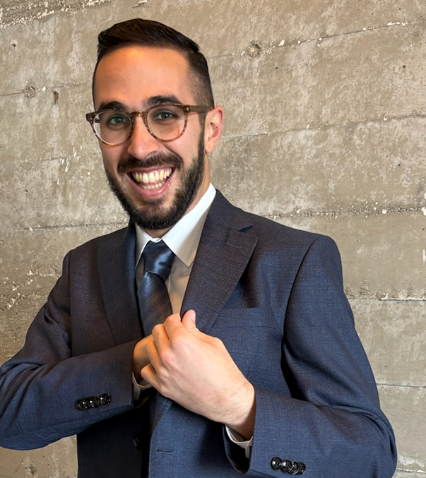 portrait man with glasses blue suit with tie lights with blurry background 1 (1)